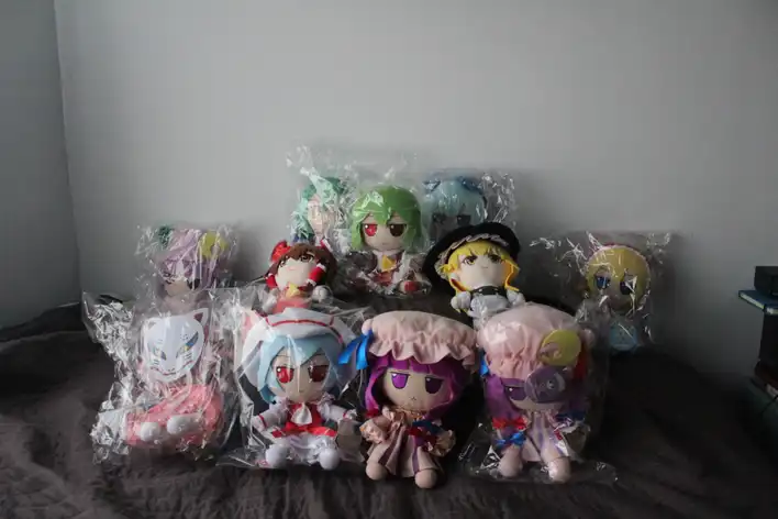 Touhou plushies sitting on my bed